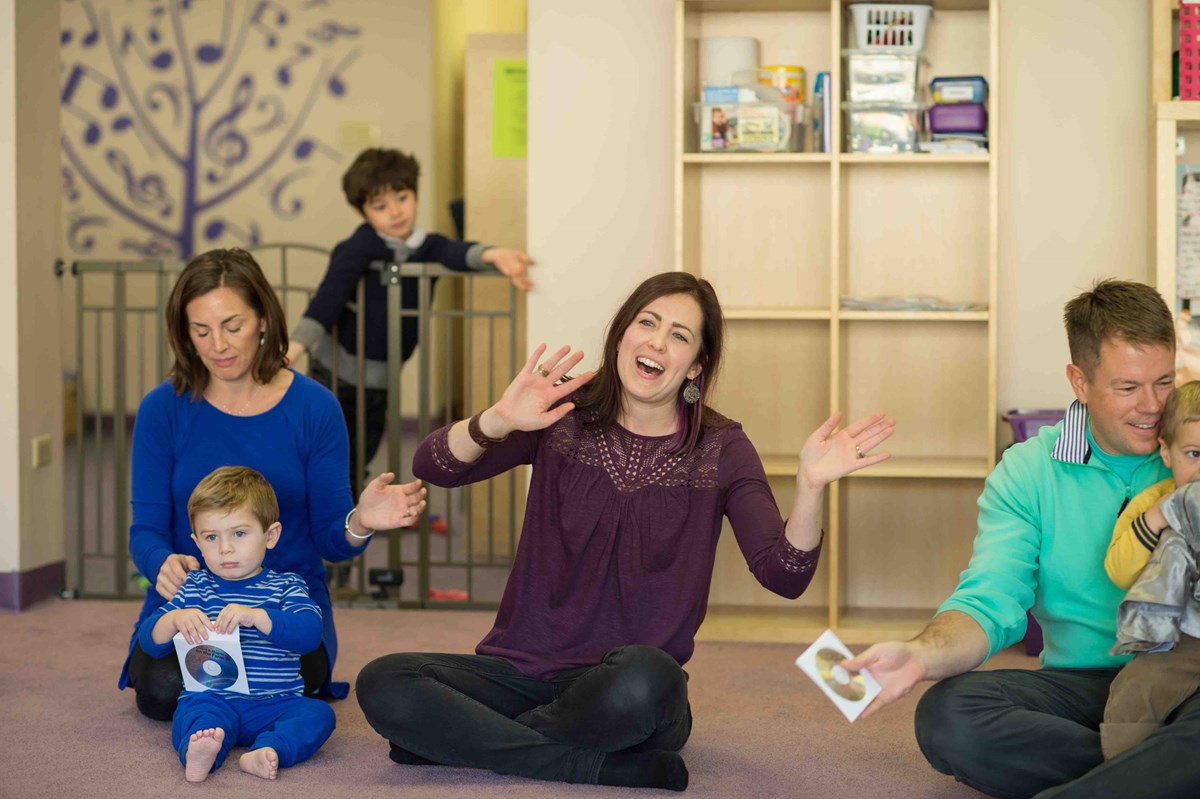 An Accredited Kindermusik Educator sings and leads her class.