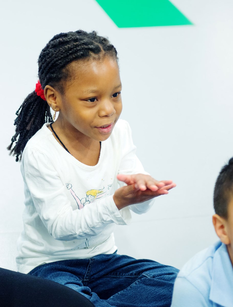 Transitional Kindergarten student clapping her hands to the beat during Kindermusik class.