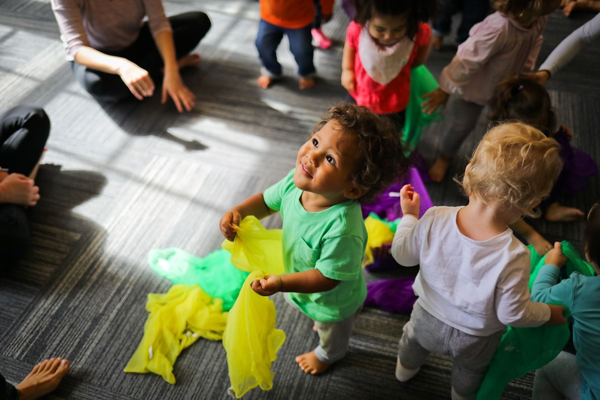 Children exploring scarves. Whole-child development through music-based learning.