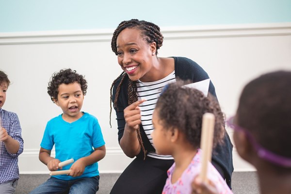 Educator teaching children how to read music in a Kindermusik class. How to become a Kindermusik Accredited Educator.