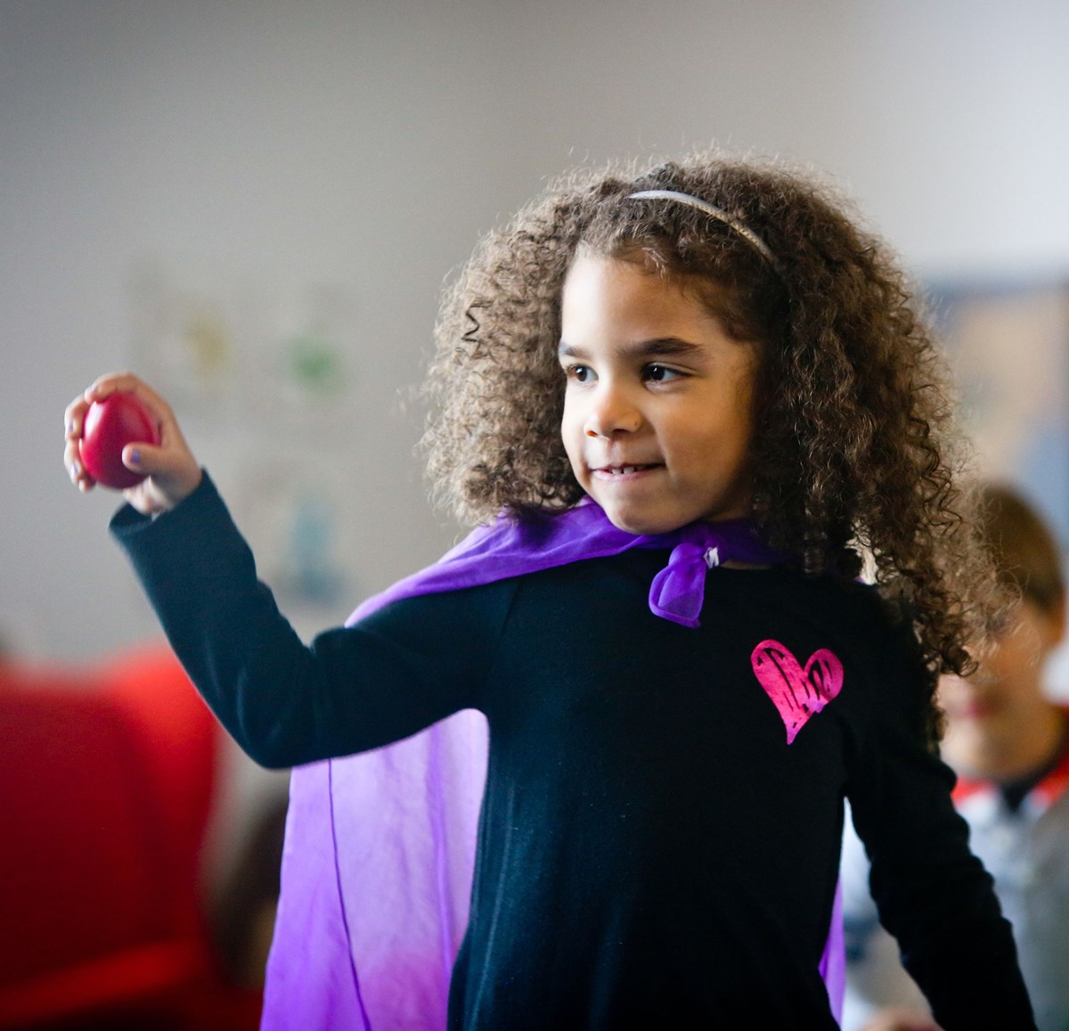 Big kid grasping egg shaker. What to expect in a music class for big kids.