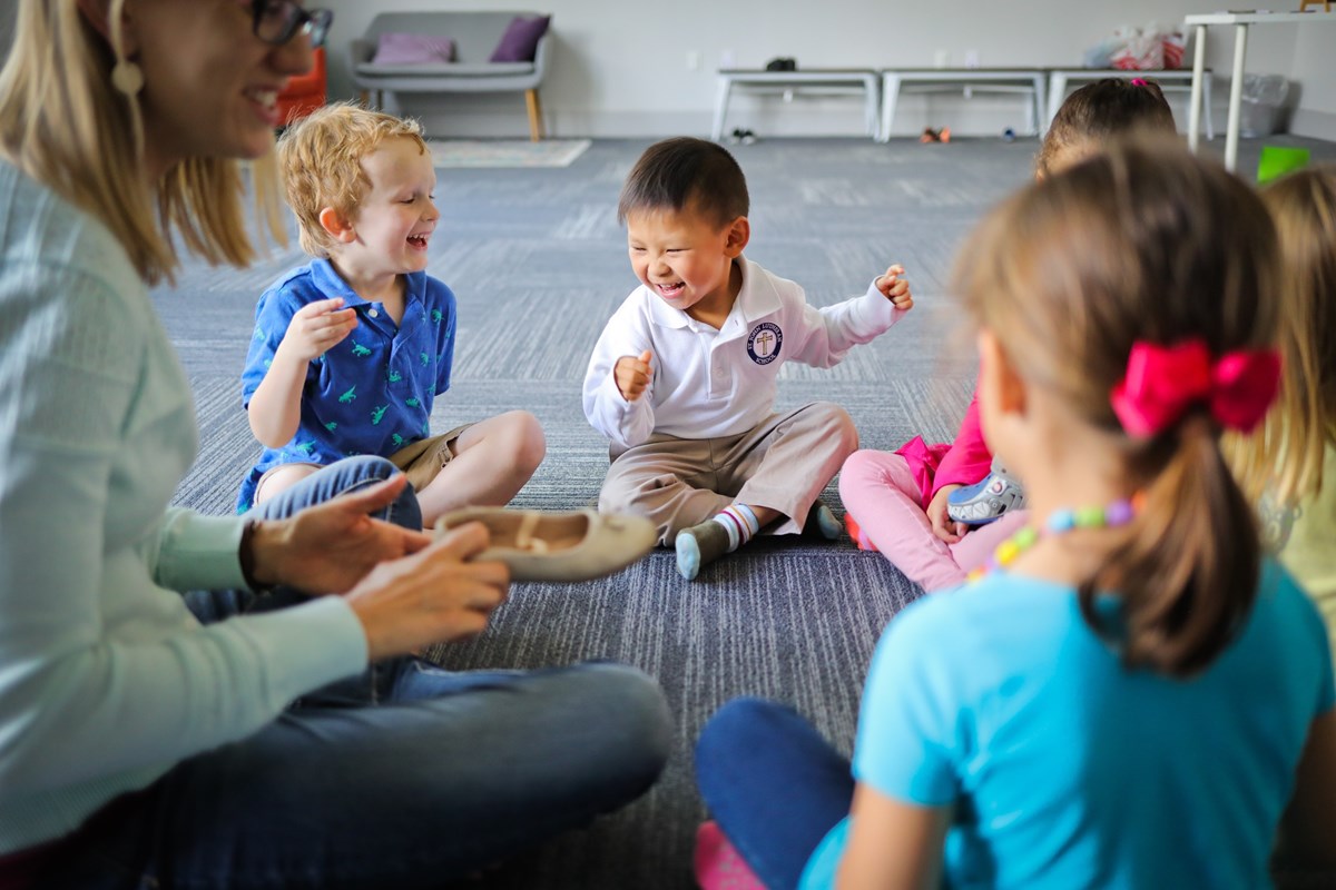 Children sitting in a circle. Music and movement research on how Kindermusik supports multiple learning styles.