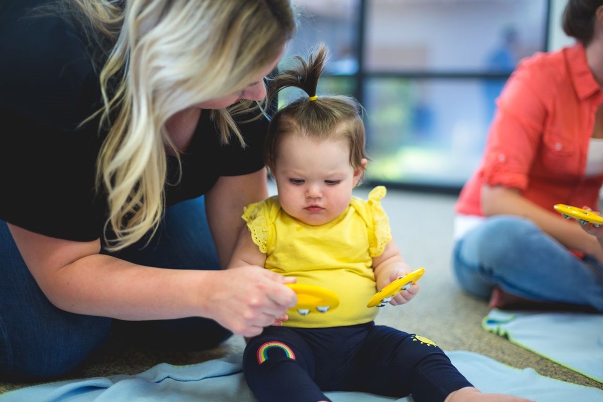 Toddler exploring bells. What you’ll learn in a music class for toddlers.