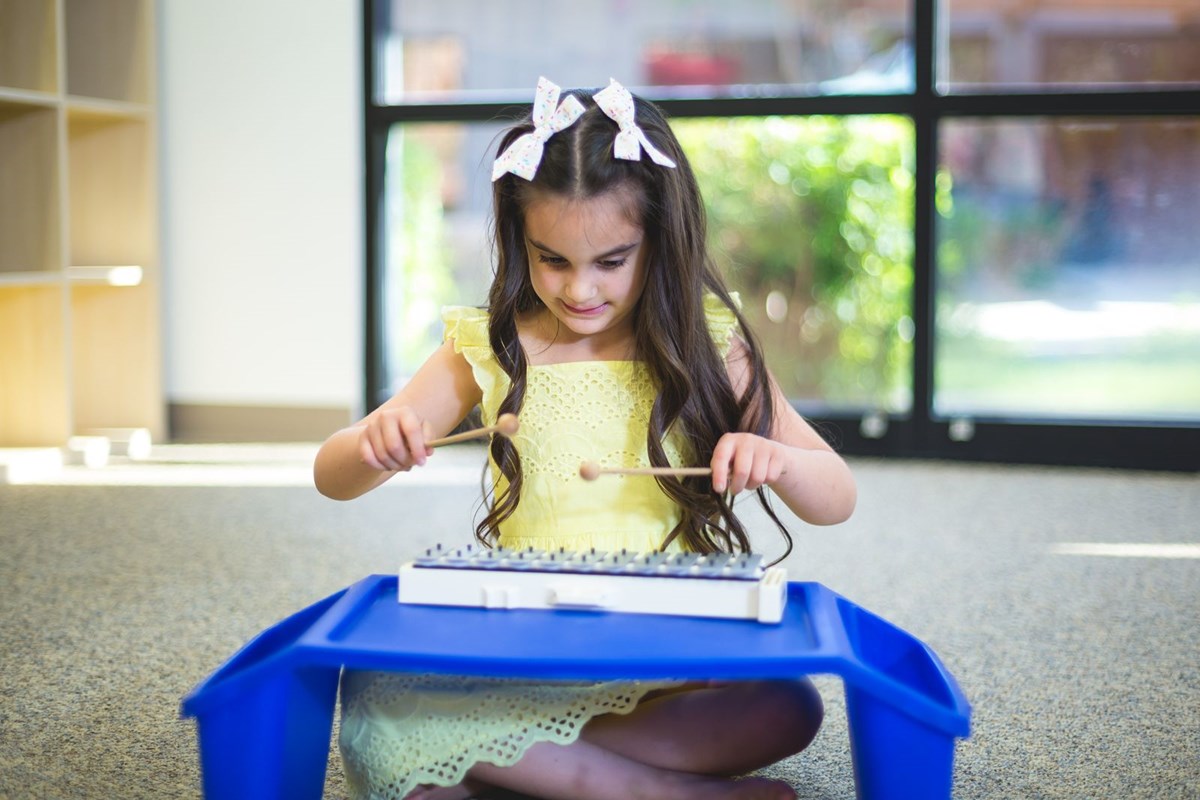 Big kid playing glockenspiel. What you’ll learn in a music class for big kids.