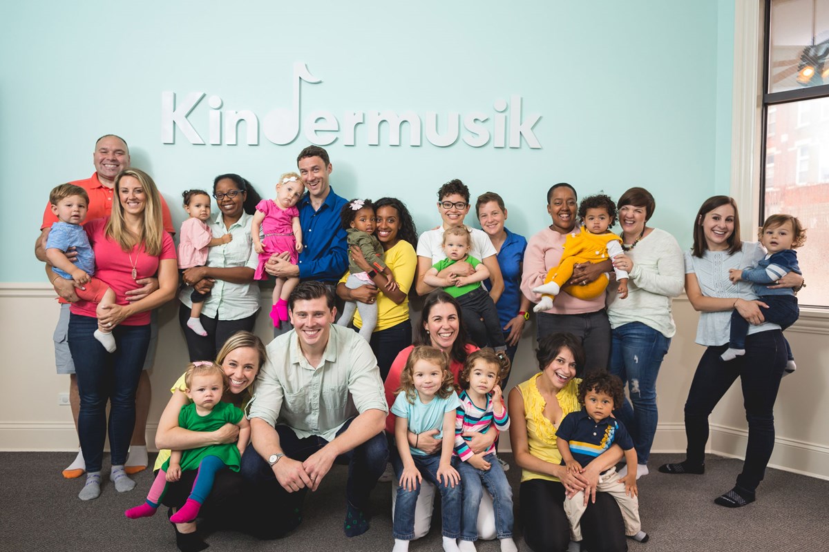 Female preschool student pointing to ear and singing during Kindermusik class. About Kindermusik’s commitment to inclusivity.